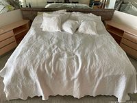 Bed showing coverlet and decorative pillows
