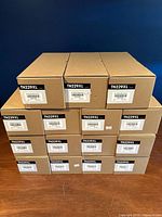Front view of all 15 sealed toner cartridge boxes stacked