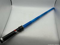 Full view of extended blue lightsaber showing blade and hilt