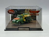 Front view of Chug die-cast truck in sealed Disney Store display case