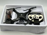 Drone, controller, battery charger, battery and cables in plastic inner tray
