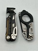 MUT multi-tool closed beside folded Raptor shears