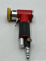 Full view of red right-angle pneumatic polisher with pad and air fitting