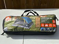 Front view of carry bag showing Ozark Trail branding, product image and capacity details