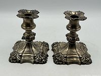 Front view of both candlesticks showing design and condition