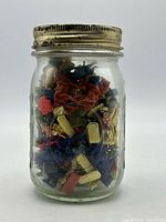 Full view of mason jar filled with multicolour plastic toy soldiers