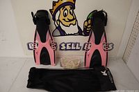 Pair of pink/black Kapitol Reef fins, wrapped mask, mesh bag overview