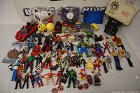 Overview of entire lot showing action figures, vehicles, masks, accessories