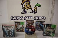 Front view of all six PS3 game cases with disc in foreground