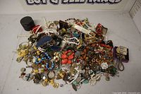 Full view of large pile of assorted costume jewelry and small boxes