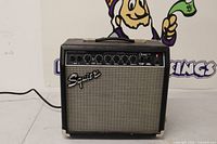 Front view of amplifier showing grille, logo, control panel and power light