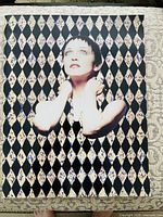 Front cover showing harlequin diamond pattern and Madonna portrait
