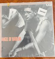 Front of sleeve with Angel of Harlem title and import sticker