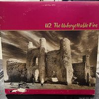 Front cover of U2 The Unforgettable Fire LP showing artwork and wear along bottom edge