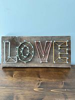 Front view of string art sign displaying all letters