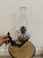 Lantern attached to ornate cast-iron bracket