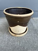 front view of stoneware planter showing two-tone glaze and attached saucer