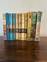 All 11 books standing with spines visible