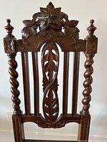 Front view showing ornate carved back, pleated leaf splat and lion mask crest