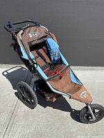 Full view of stroller profile showing frame, wheels, fabric