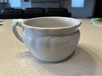 Side view showing handle and wheat relief pattern