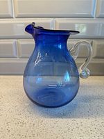 Front view showing jug shape, spout, color gradient