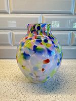 Front view of multicolour splatter blown glass vase