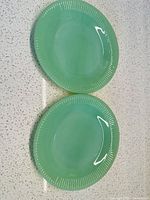 Front view of both jadeite Jane Ray plates showing ribbed border
