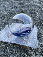 Side view of clear glass float ball showing weight loop