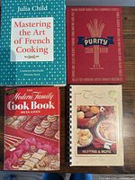 All four cookbooks laid out showing front covers