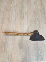 Broad axe full length on floor