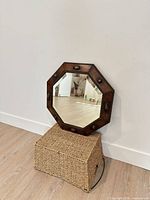 Front view of octagonal oak mirror leaning against wall