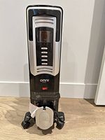 Front view showing control panel, brand logo, power switch and caster base