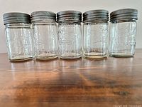 Front view of five jars side by side