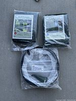 Two retail-packaged shrub protectors and one folded pop-up cloche