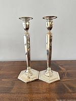 Front view of both silver plated candlesticks