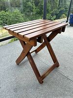Full view of teak folding table on patio