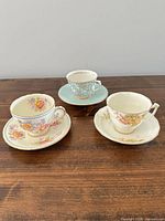 All three teacup and saucer sets grouped