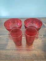 group shot of two cranberry bowls and two tumblers
