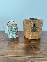Teapot and wicker carrier side by side