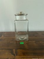 Front view of square glass jar with metal lid