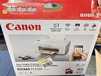 Front of retail box showing Canon PIXMA TS3120 printer image and branding