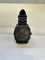 Front view showing dial and strap