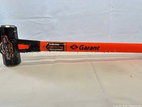 Side view of entire Garant sledgehammer showing fiberglass handle and steel head