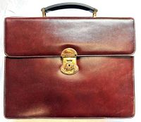 Front view showing leather color, push-lock clasp, top handle