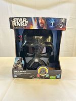 Front view of boxed Darth Vader voice changer mask showing product and branding