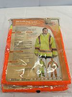 Front of packaged hi-vis rain jacket showing model information and features