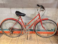 Full left-side view of red Le Circuit bicycle