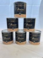 Front view of six stacked ZAR stain cans showing labels, brand, color, size