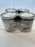 Four shrink-wrapped cans of ZAR Interior Oil Base Stain Mink shade, front view